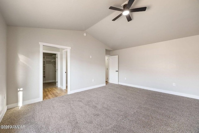 780 E Cobble Ln, Taylor, AZ 85939 - unfurnished bedroom featuring light colored carpet, vaulted ceiling, a spacious closet, baseboards, and ceiling fan