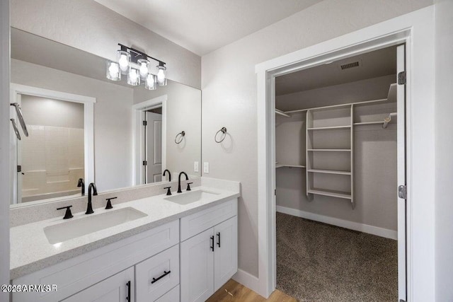 780 E Cobble Ln, Taylor, AZ 85939 - bathroom featuring a spacious closet, double vanity, and baseboards