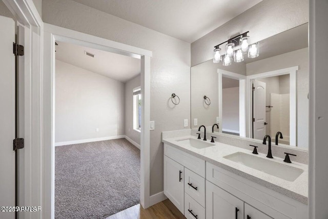 780 E Cobble Ln, Taylor, AZ 85939 - bathroom featuring a shower, double vanity, baseboards, and wood finished floors