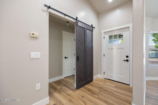 780 E Cobble Ln, Taylor, AZ 85939 - entrance foyer featuring a barn door, light wood-type flooring, and baseboards