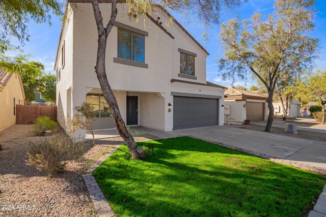 view of front of property with a garage and a front lawn