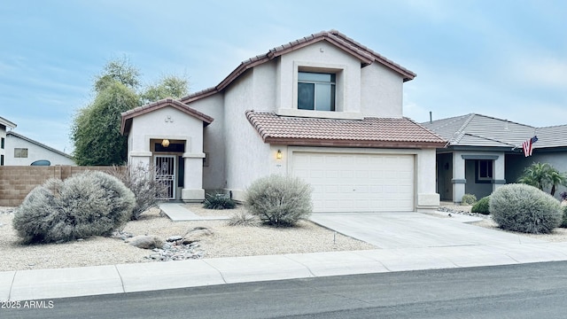 view of front of house featuring a tile roof, stucco siding, concrete driveway, and fence