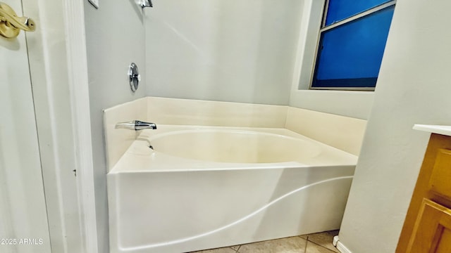 bathroom featuring tile patterned flooring and a garden tub