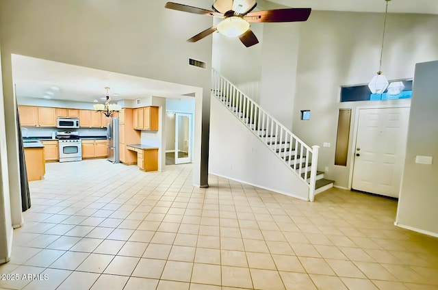 17059 W Northampton Rd, Surprise, AZ 85374 - unfurnished living room featuring stairway, a towering ceiling, a chandelier, ceiling fan, and baseboards