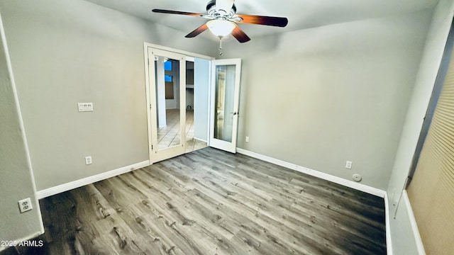 unfurnished bedroom with wood finished floors, baseboards, and ceiling fan