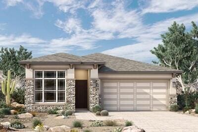 prairie-style home featuring a garage, stucco siding, stone siding, and decorative driveway
