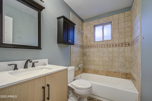 full bath featuring toilet, vanity, bathtub / shower combination, a textured wall, and a textured ceiling