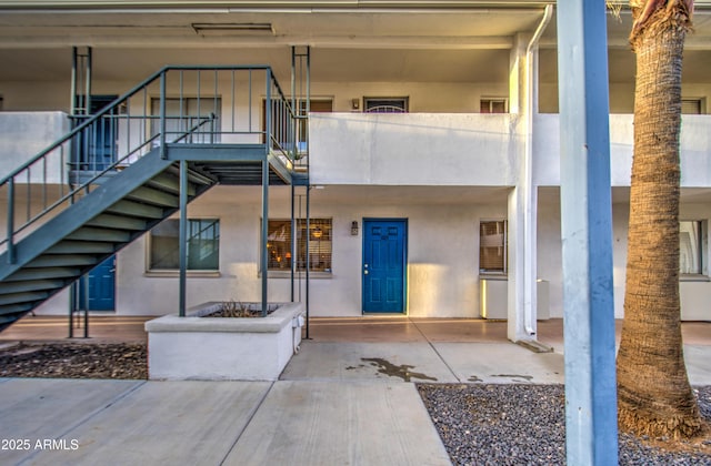 entrance to property featuring stucco siding