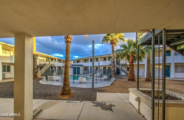 exterior space with a patio area, stairs, and fence