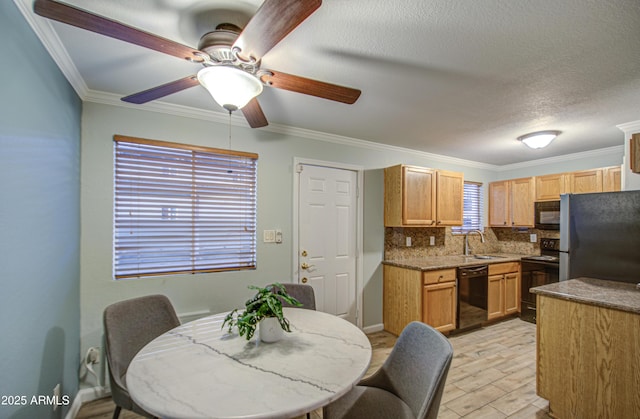 kitchen with light wood finished floors, ceiling fan, decorative backsplash, black appliances, and a sink