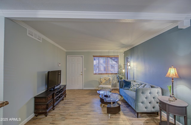 living room featuring light wood-type flooring, visible vents, and ornamental molding