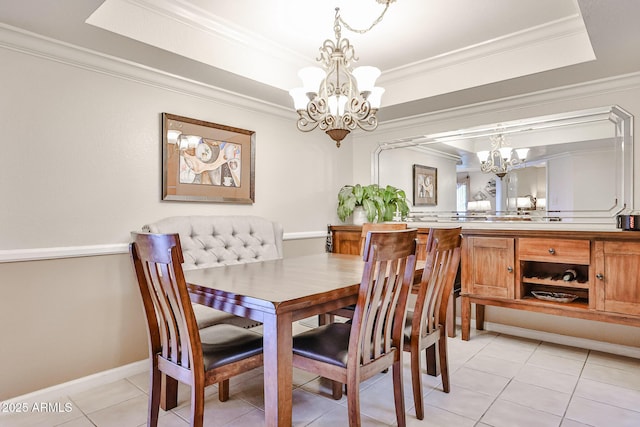17404 N 99th Ave Unit 318, Sun City, AZ 85373 - dining space with a chandelier, crown molding, light tile patterned flooring, and a tray ceiling