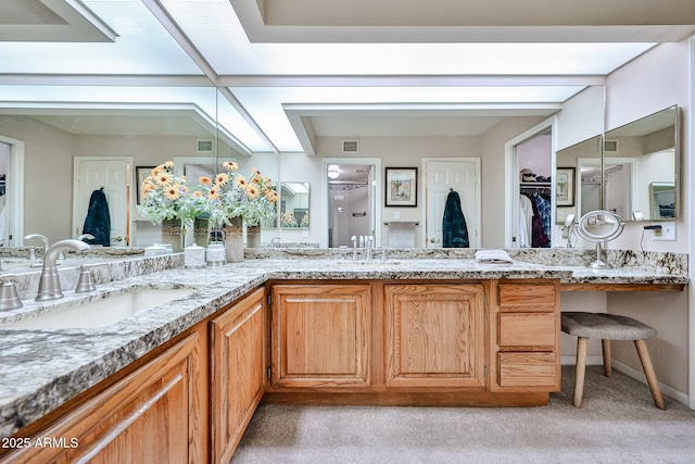 17404 N 99th Ave Unit 318, Sun City, AZ 85373 - full bathroom featuring a sink, visible vents, a spacious closet, and double vanity
