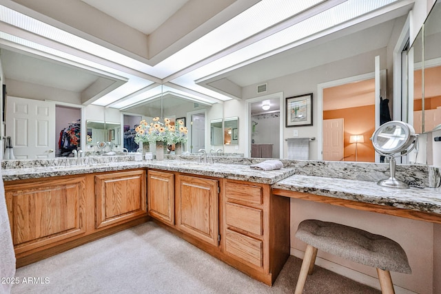 17404 N 99th Ave Unit 318, Sun City, AZ 85373 - bathroom with a shower, visible vents, a sink, and double vanity