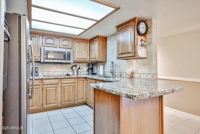 17404 N 99th Ave Unit 318, Sun City, AZ 85373 - kitchen with a sink, appliances with stainless steel finishes, light tile patterned flooring, and a peninsula