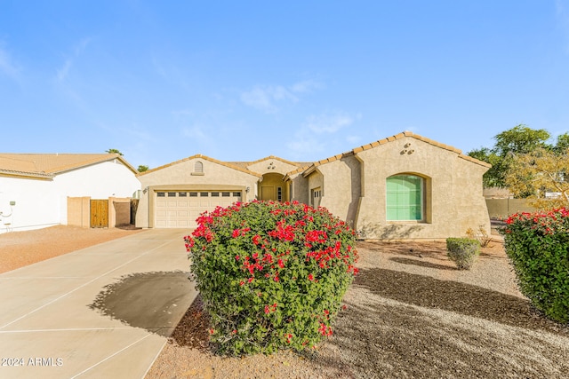 mediterranean / spanish-style home featuring a garage