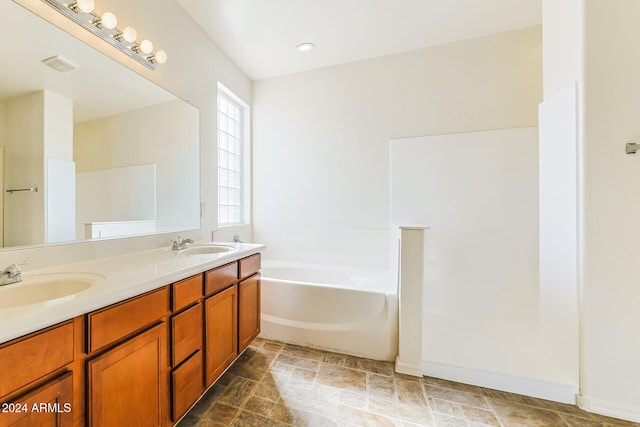 bathroom with vanity and a bath