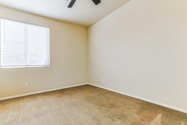 carpeted empty room with ceiling fan and lofted ceiling