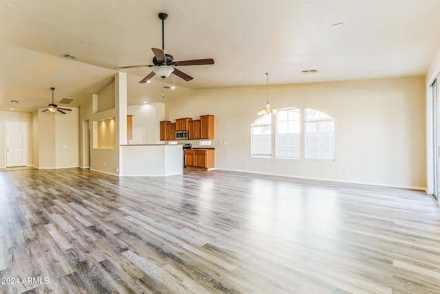 unfurnished living room with light hardwood / wood-style flooring, ceiling fan with notable chandelier, and lofted ceiling