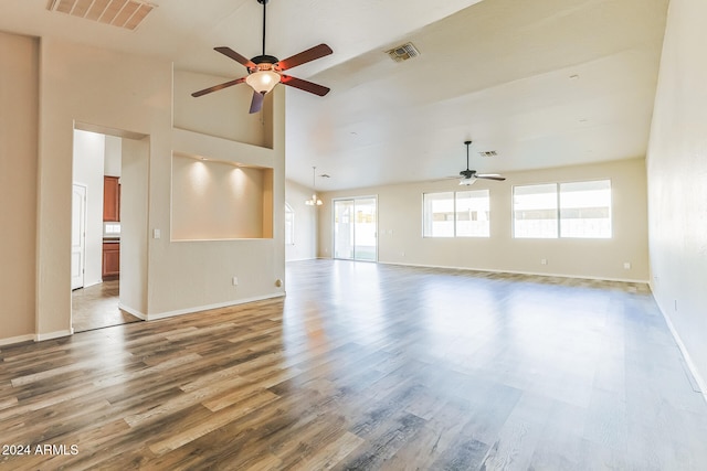 unfurnished living room with hardwood / wood-style floors, high vaulted ceiling, and ceiling fan