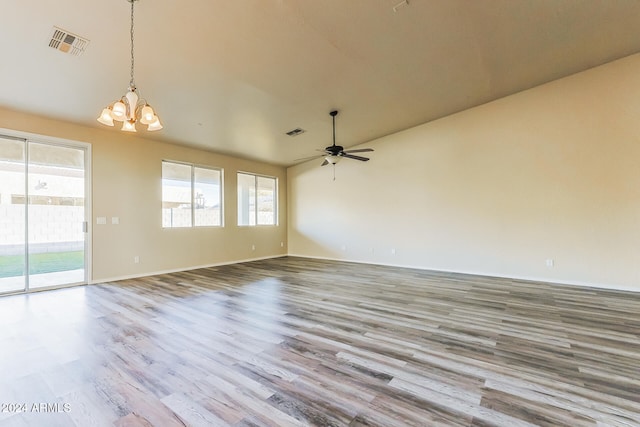 unfurnished room featuring light hardwood / wood-style flooring and ceiling fan with notable chandelier