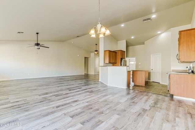 kitchen with decorative light fixtures, ceiling fan with notable chandelier, light hardwood / wood-style floors, and high vaulted ceiling