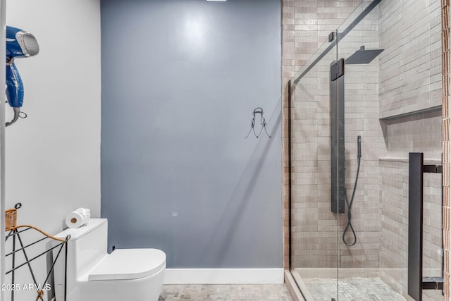 bathroom with a shower with door and toilet