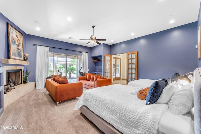 bedroom with light carpet, ceiling fan, and french doors