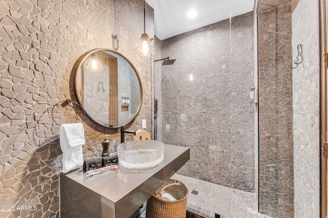 bathroom featuring sink and a tile shower