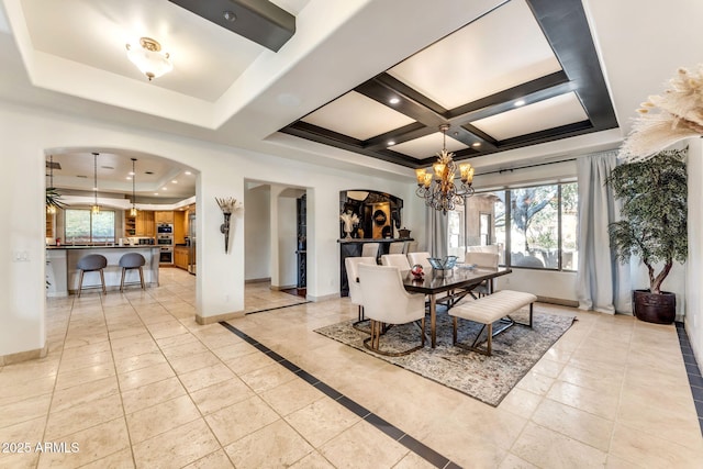 tiled dining room with beam ceiling, coffered ceiling, a chandelier, and a tray ceiling