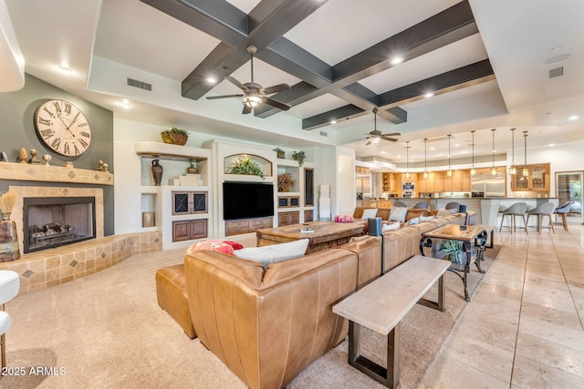 living room with ceiling fan, coffered ceiling, and beam ceiling