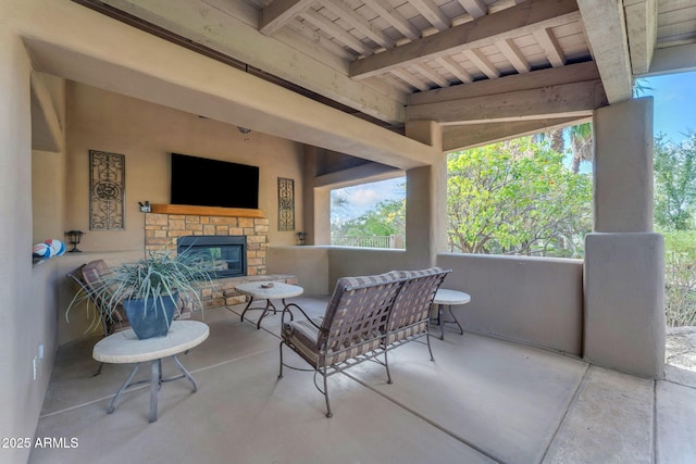 view of patio featuring an outdoor stone fireplace