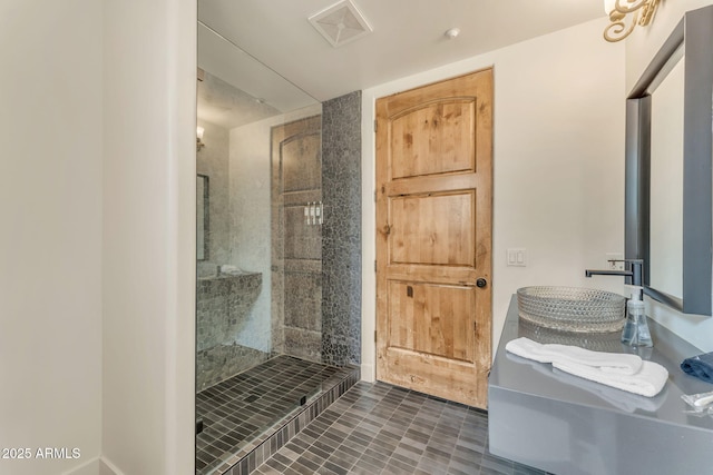 bathroom featuring sink and a tile shower