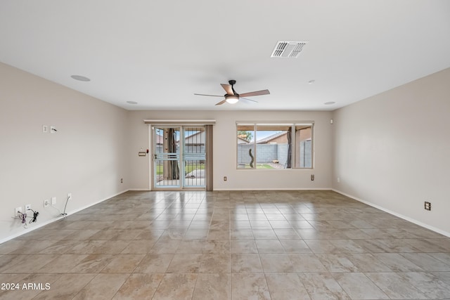 spare room featuring light tile patterned floors and ceiling fan