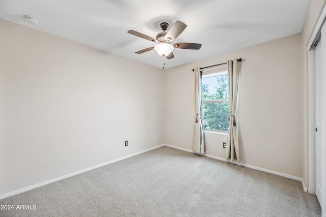 spare room with carpet flooring and ceiling fan