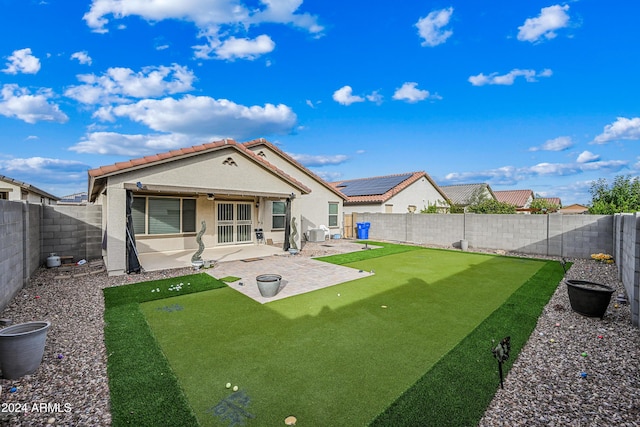 back of house featuring ceiling fan and a patio area