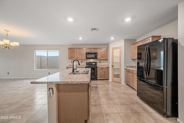 kitchen with sink, hanging light fixtures, an inviting chandelier, a kitchen island with sink, and black appliances