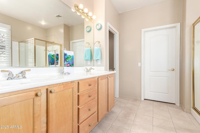 full bath with tile patterned flooring, a sink, visible vents, double vanity, and a stall shower