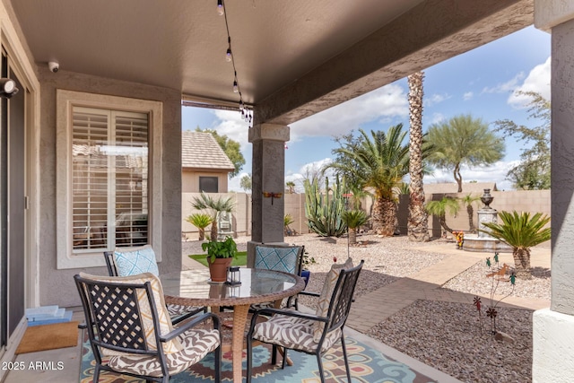 view of patio featuring a fenced backyard and outdoor dining area