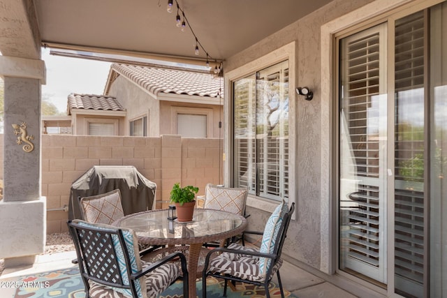 view of patio / terrace with outdoor dining area, a grill, and fence