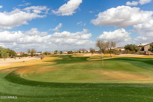 view of home's community with golf course view and a lawn