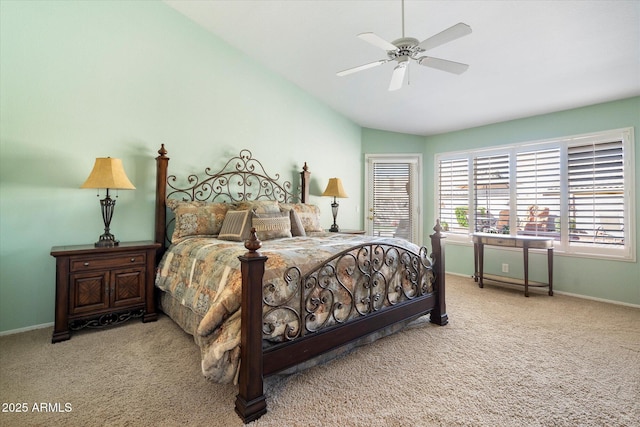 carpeted bedroom featuring lofted ceiling, a ceiling fan, and baseboards