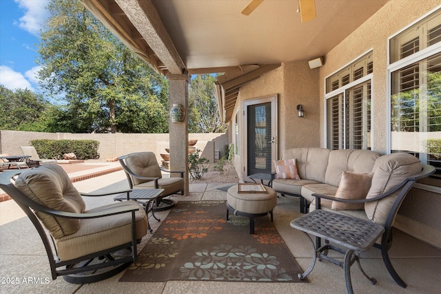 view of patio / terrace with an outdoor living space, a fenced backyard, and ceiling fan