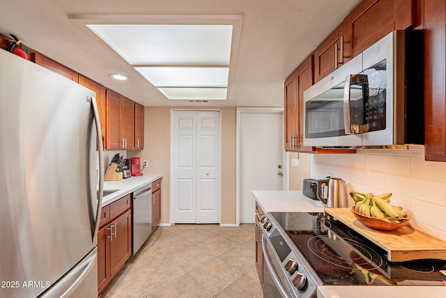 7764 N 19th Dr, Phoenix, AZ 85021 - kitchen with stainless steel appliances, light tile patterned flooring, and decorative backsplash