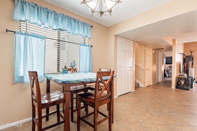 7764 N 19th Dr, Phoenix, AZ 85021 - dining area featuring an inviting chandelier, tile patterned flooring, and a textured ceiling