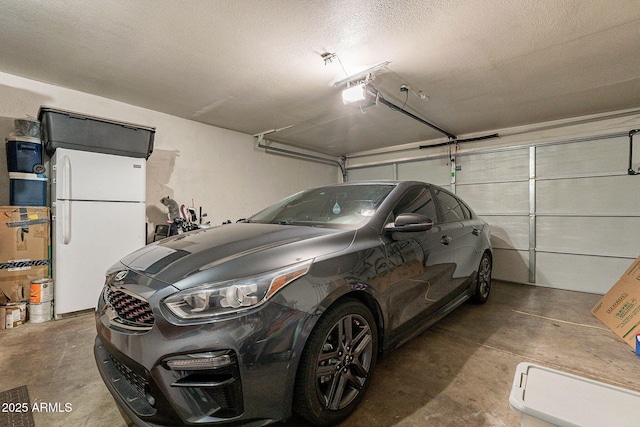 7764 N 19th Dr, Phoenix, AZ 85021 - garage with a garage door opener and white fridge