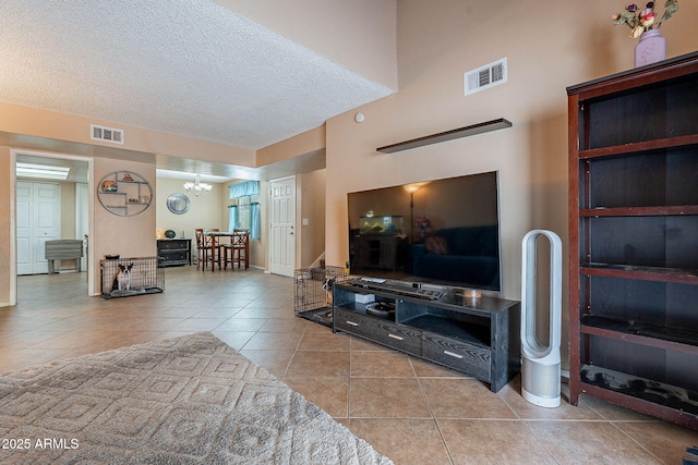7764 N 19th Dr, Phoenix, AZ 85021 - living room with an inviting chandelier, a textured ceiling, and light tile patterned floors