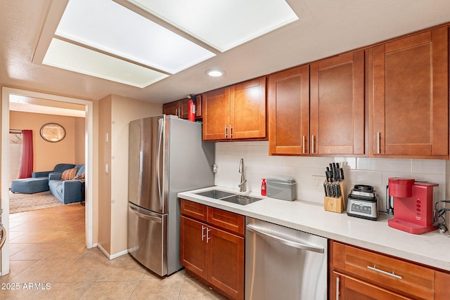 7764 N 19th Dr, Phoenix, AZ 85021 - kitchen with tasteful backsplash, sink, light tile patterned floors, and appliances with stainless steel finishes