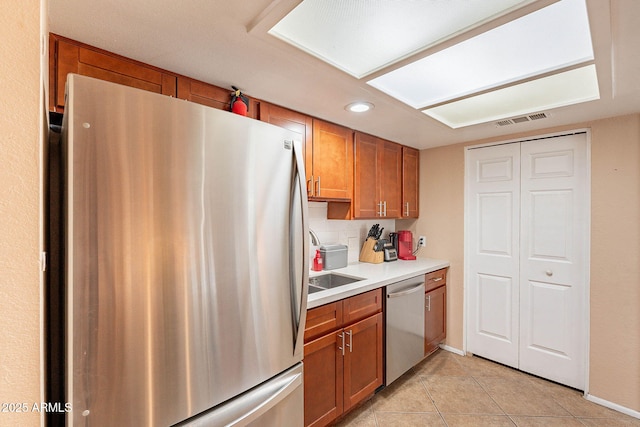 7764 N 19th Dr, Phoenix, AZ 85021 - kitchen with light tile patterned flooring, appliances with stainless steel finishes, and backsplash