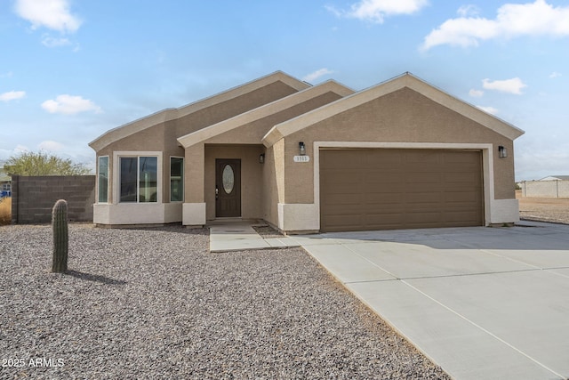 ranch-style home with driveway, a garage, fence, and stucco siding